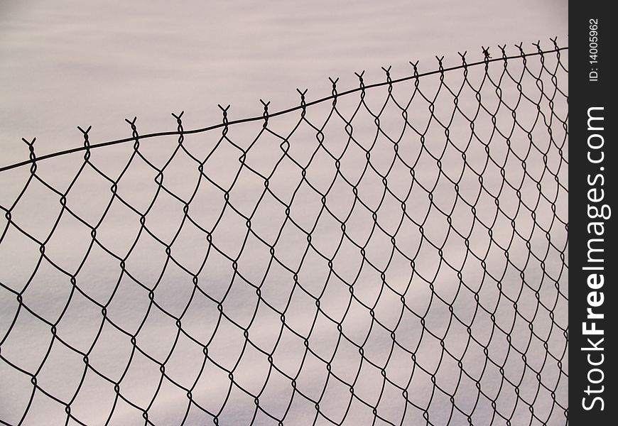 Wire fence with snow background