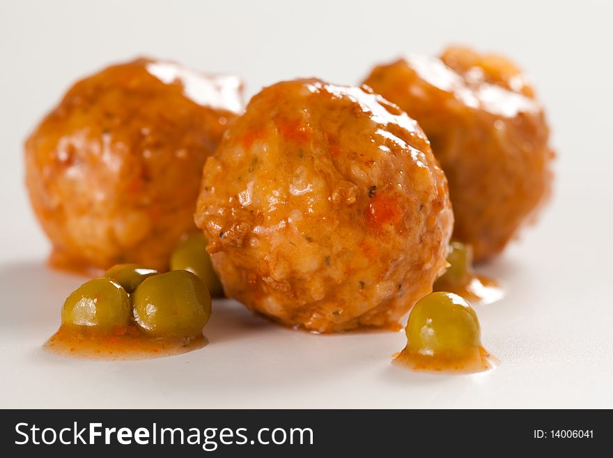 Plate of meatballs with sauce and green peas. Plate of meatballs with sauce and green peas