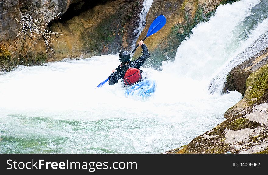 A shot of the female kayaker on the rough water