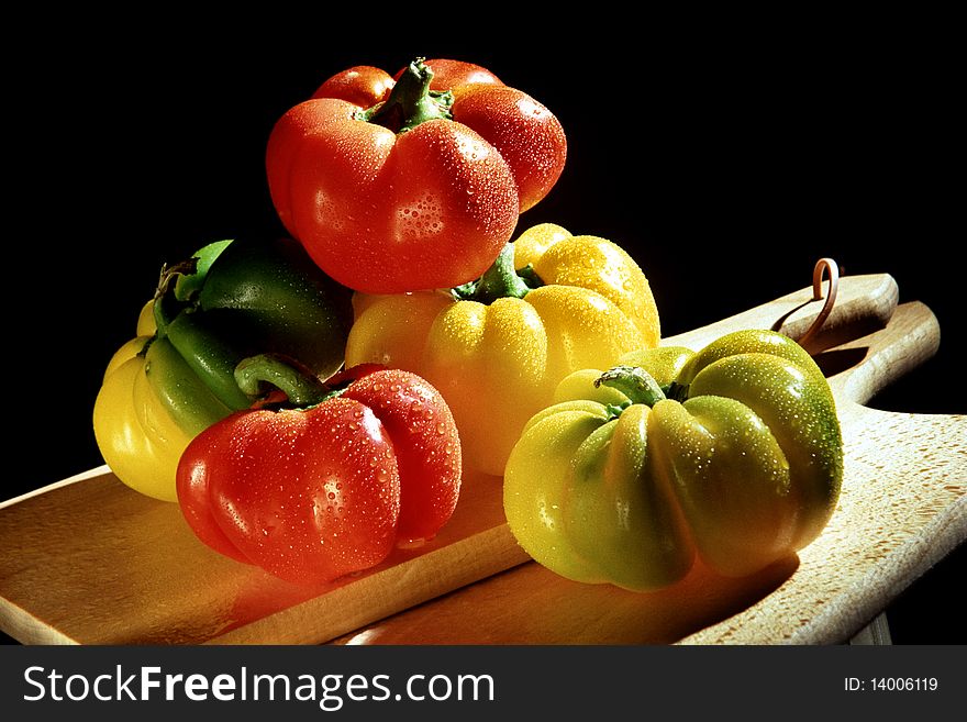 Colourful peppers on chopping board. Colourful peppers on chopping board