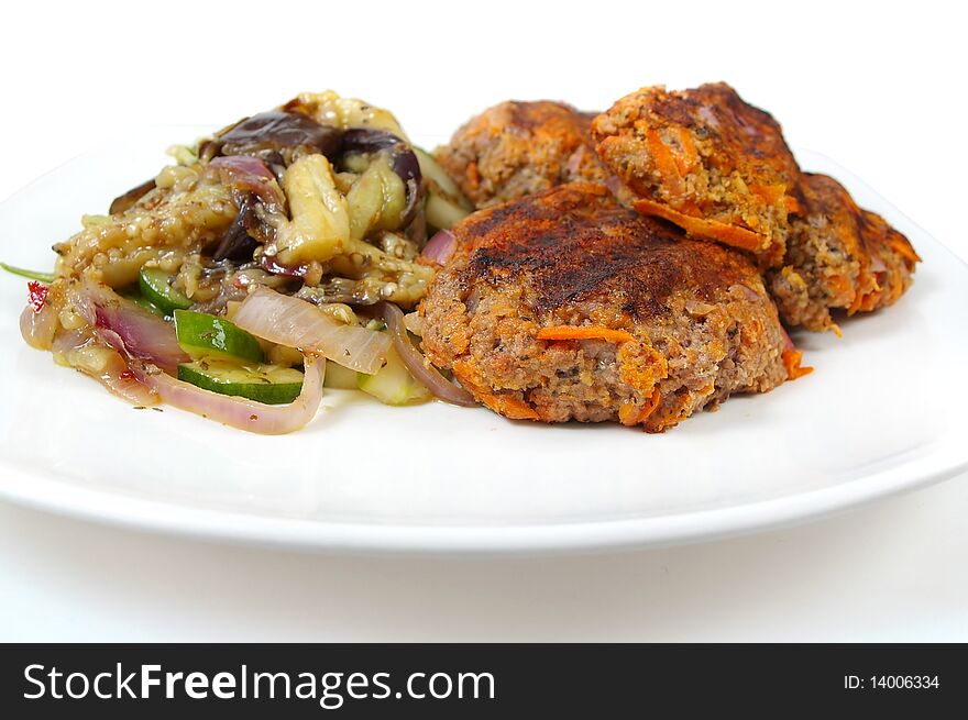 Rissole and egg plant with cucumber salad dinner on plate. Rissole and egg plant with cucumber salad dinner on plate