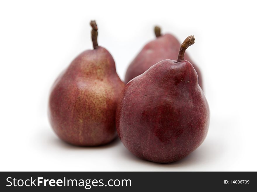 Three pears of red colour on a white background