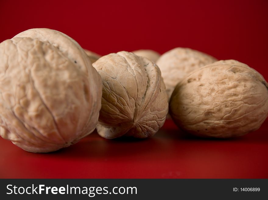 Handful of walnuts on a red background. Handful of walnuts on a red background