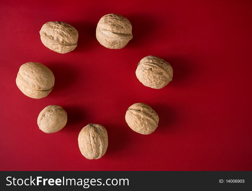 Range from walnuts on a red background. Range from walnuts on a red background