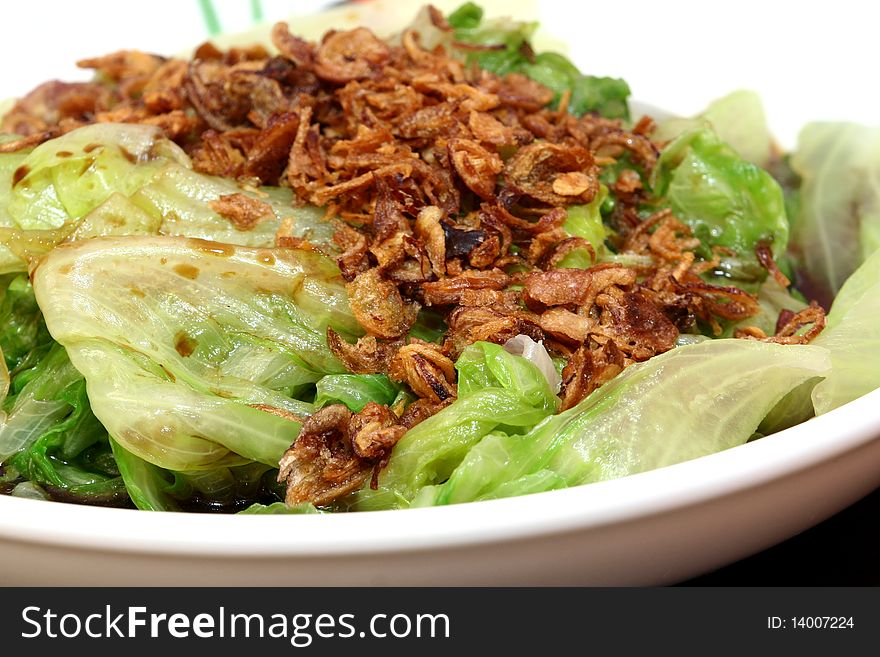 Fresh steamed vegetables with cut deep fried onions.