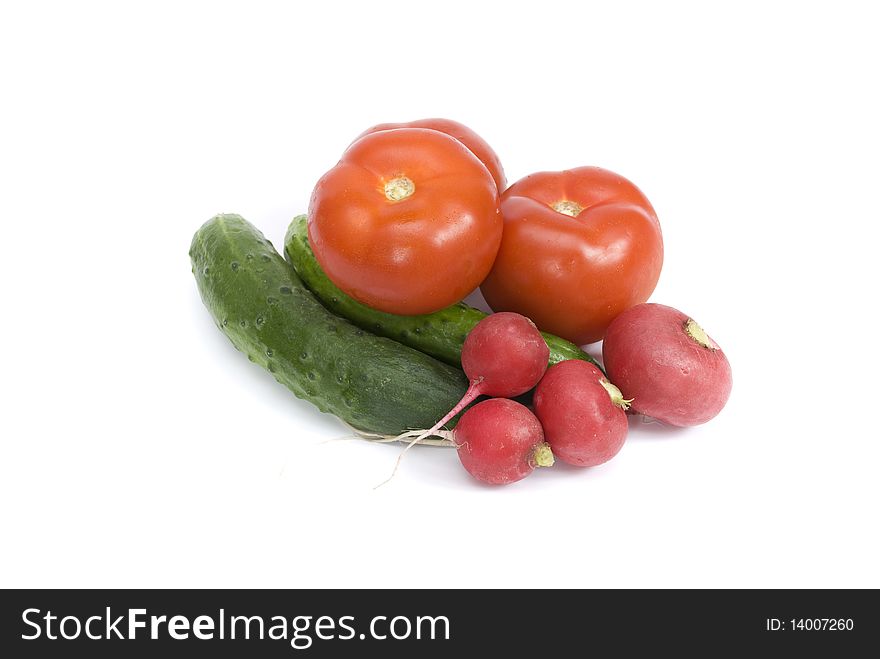 Tomatoes, cucumbers and radishes on a white background. Tomatoes, cucumbers and radishes on a white background