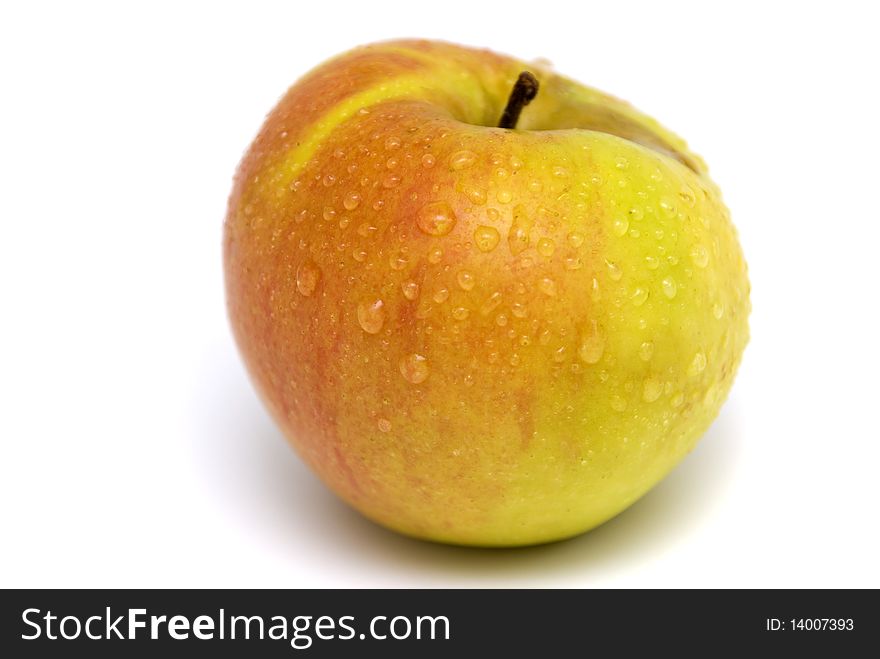 Ripe apple covered in water droplets isolated on a white