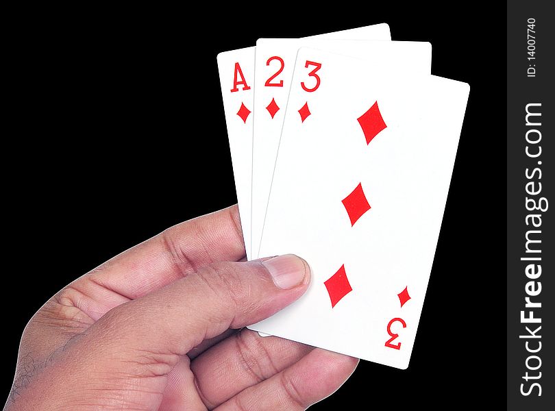 Hand with playing cards in black background