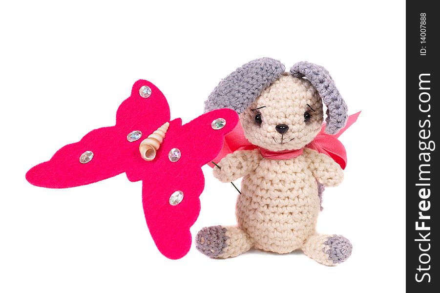 Knitted toy. Hare with butterfly