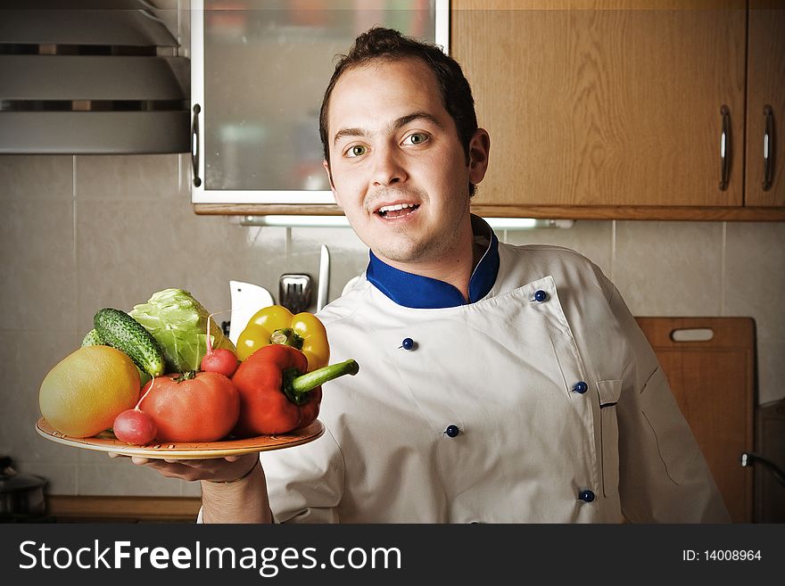 Happy Man With Vegetables On Kitchen