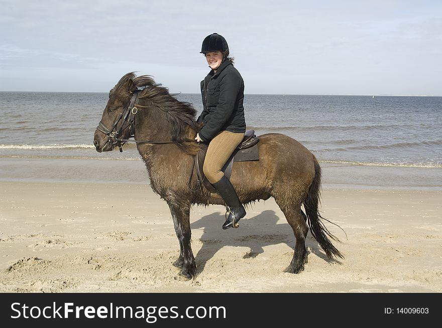 Two amazones on horseback on the beach and in sea