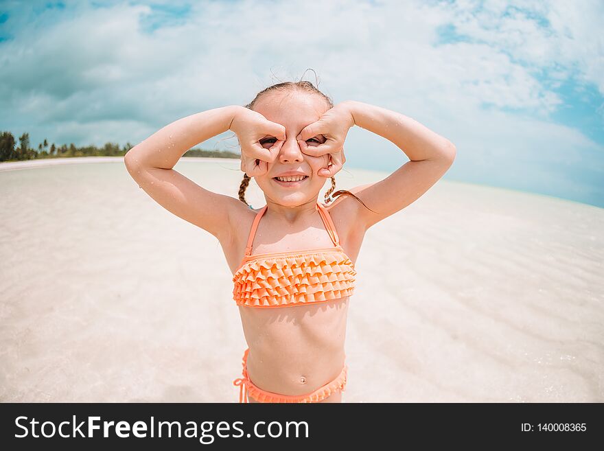 Cute little girl at beach during summer vacation