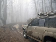 Dirty Road And 4x4 Car In Mist Forest Stock Photos Dirty Road And 4x4 Car In Mist Forest Stock Photos
