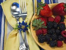 Berries On A Yellow Plate With Silverware Royalty Free Stock Images