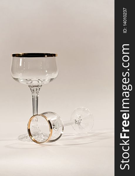 Picture of two glasses. One standing, one fallen. Picture of two glasses. One standing, one fallen.