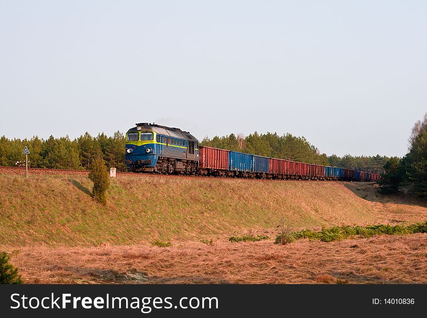 Freight train hauled by two diesel locomotives passing the forest. Freight train hauled by two diesel locomotives passing the forest