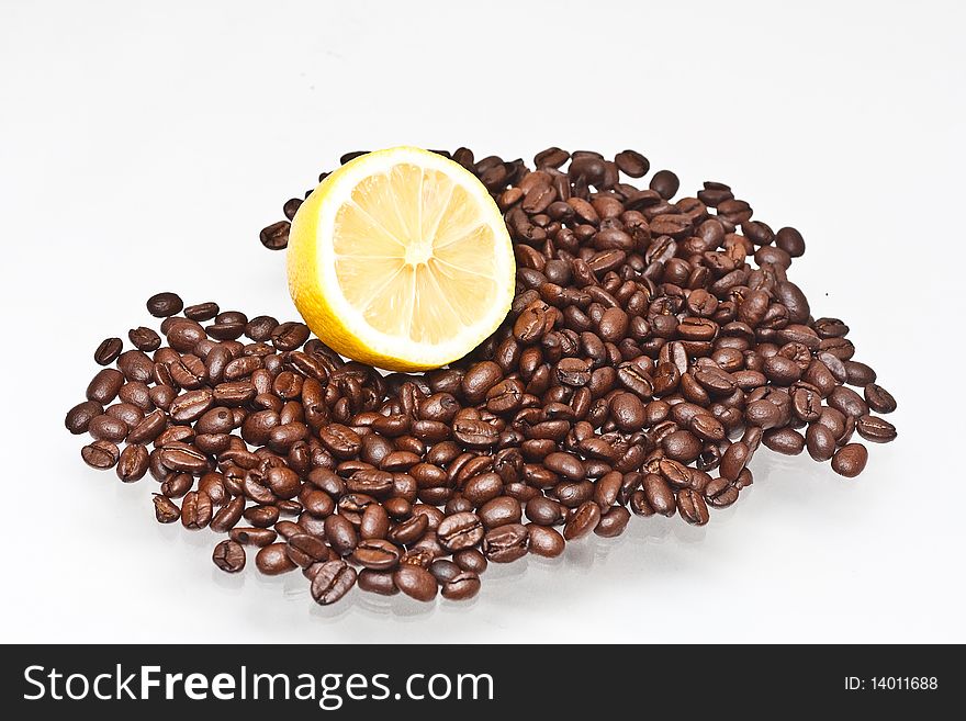 Coffee beans & lemon on a white background. Coffee beans & lemon on a white background