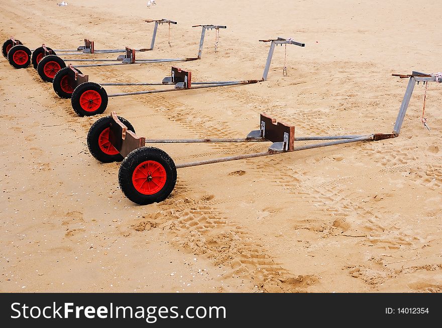 Truck for yachts on the sandy beach as a symbol of teamwork