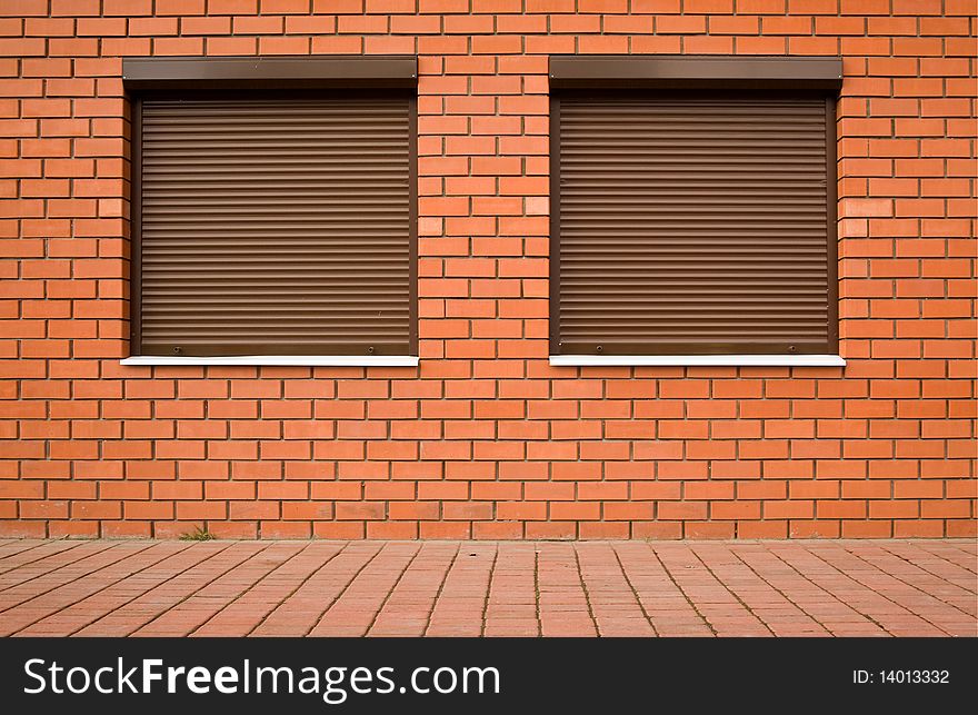 Wall from a red brick and by windows