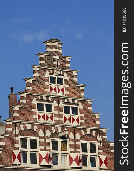 Windows with shutters in a traditional pattern on a classic crow stepped gable. Windows with shutters in a traditional pattern on a classic crow stepped gable