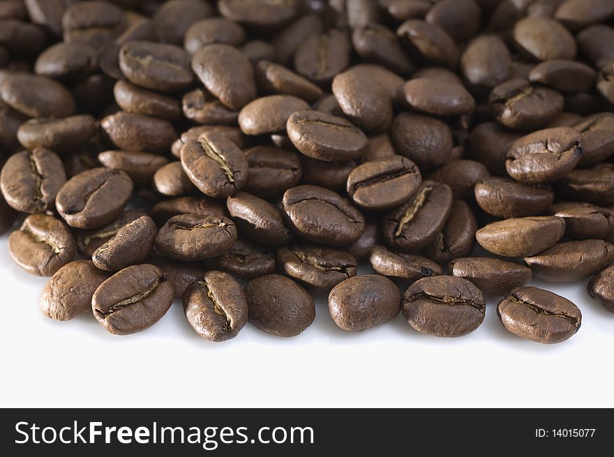 An arrangement of coffee beans on a white background. An arrangement of coffee beans on a white background