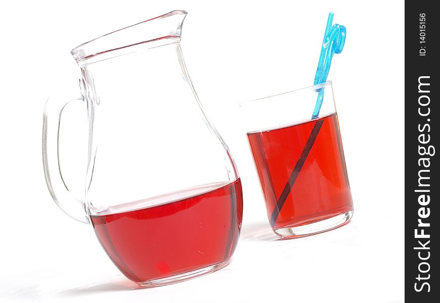 Jucie in a glass and in a jug on white background. Jucie in a glass and in a jug on white background