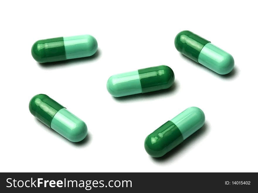 Green pills isolated on white