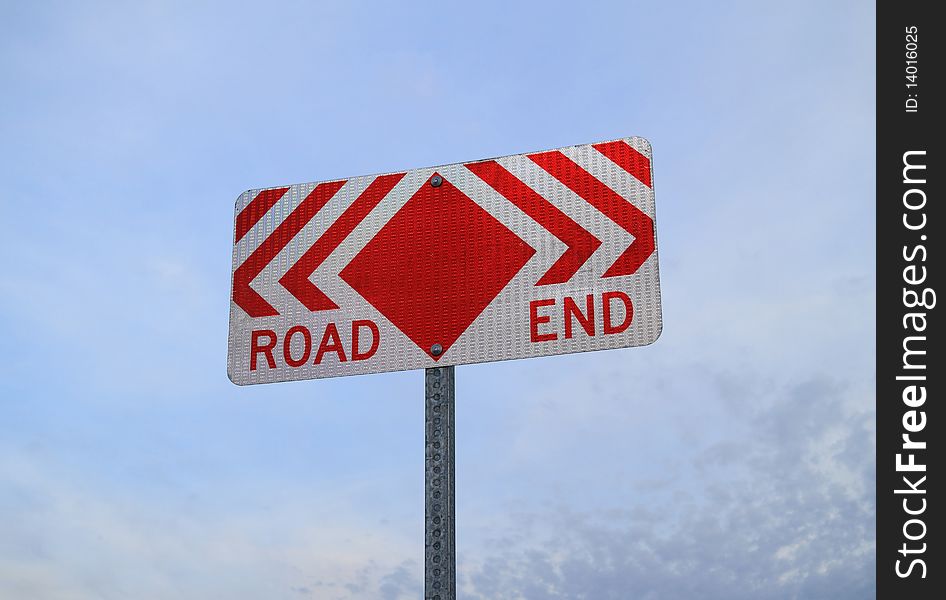 Reflective road sign stating Road End . Sign is on a metal pole with a sky with scattered clouds in background. Reflective road sign stating Road End . Sign is on a metal pole with a sky with scattered clouds in background