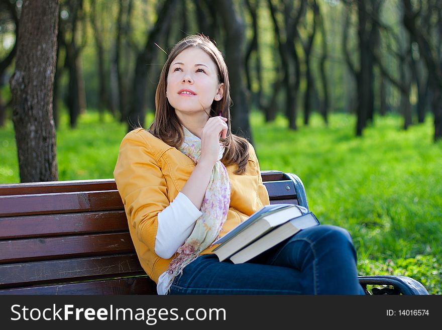 Woman With Book In Park