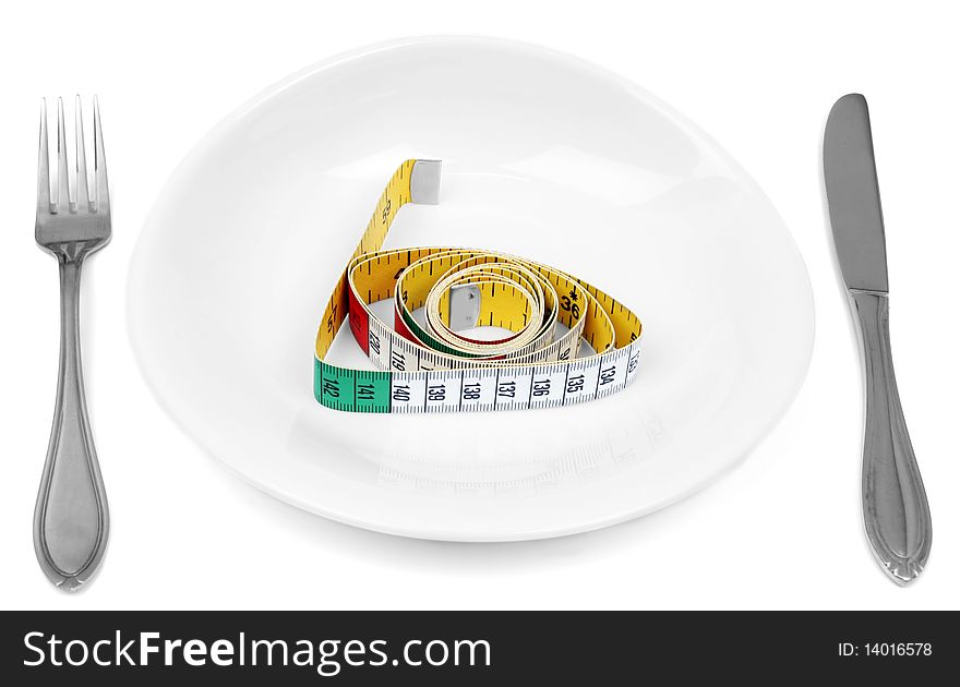 Cutlery and measuring tape on white plate