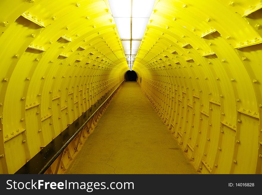 Yellow steel tunnel creates an impression being aboard alien spaceship. Yellow steel tunnel creates an impression being aboard alien spaceship.