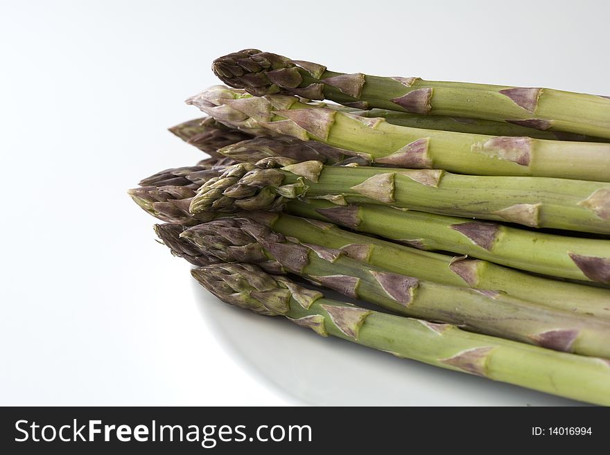 Fresh and healthy asparagus spears against a white background. Fresh and healthy asparagus spears against a white background.