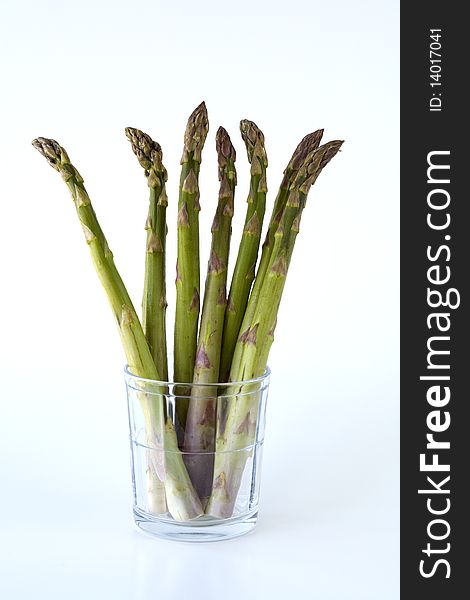 Concept image of asparagus spears in a glass. Concept image of asparagus spears in a glass.
