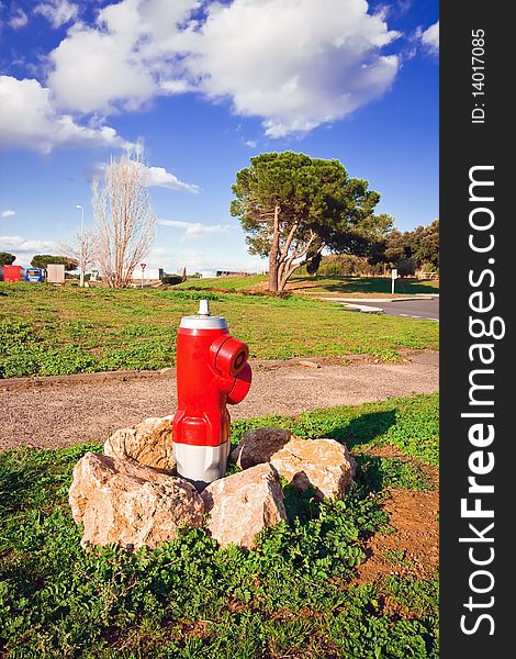 Red fire hydrant between the stones in the countryside