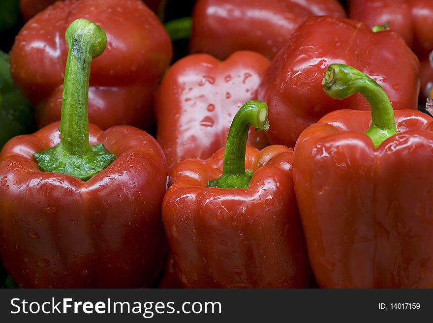 Bright red bell peppers with green stems. Bright red bell peppers with green stems.