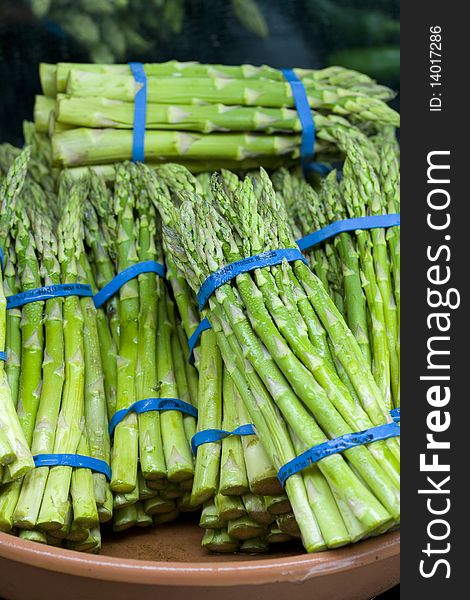 Fresh asparagus spears are banded together for display. Fresh asparagus spears are banded together for display.