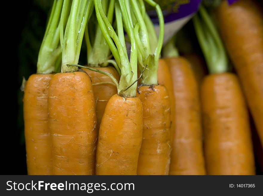 A bunch of raw carrots being displayed. A bunch of raw carrots being displayed.