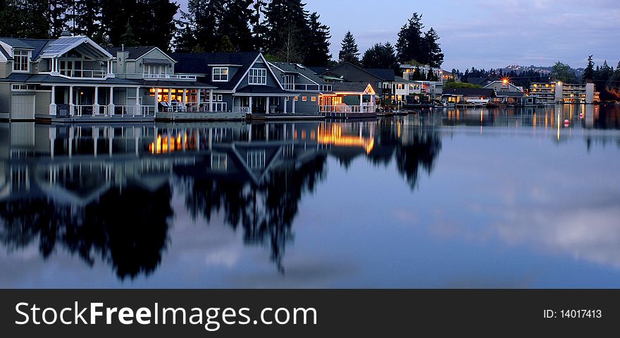 This picture is a group of lakeside houses just after dark. This picture is a group of lakeside houses just after dark.