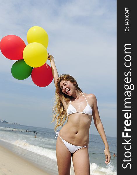 Woman Holding Colorful Balloons On The Beach