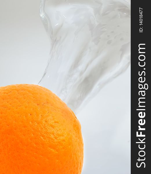 An orange on splashing water background. An orange on splashing water background