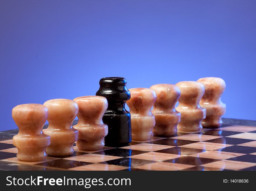 Marble chess on chessboard with blue background