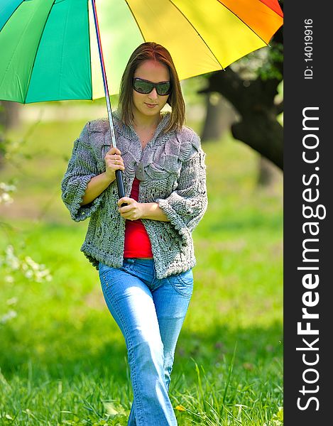 Beautiful woman with umbrella in rainbow collors