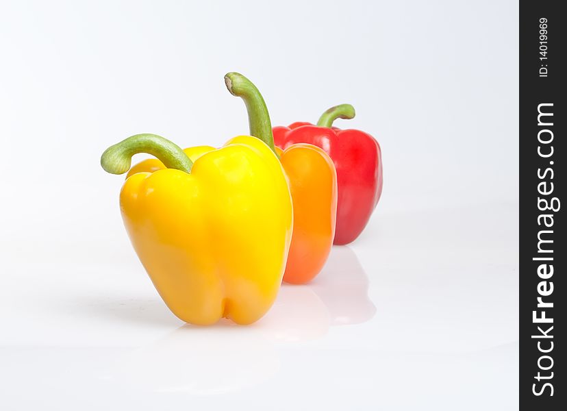 Three different color peppers on white background. Three different color peppers on white background