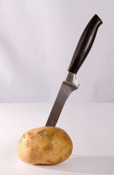 Knife In Potato Stock Image