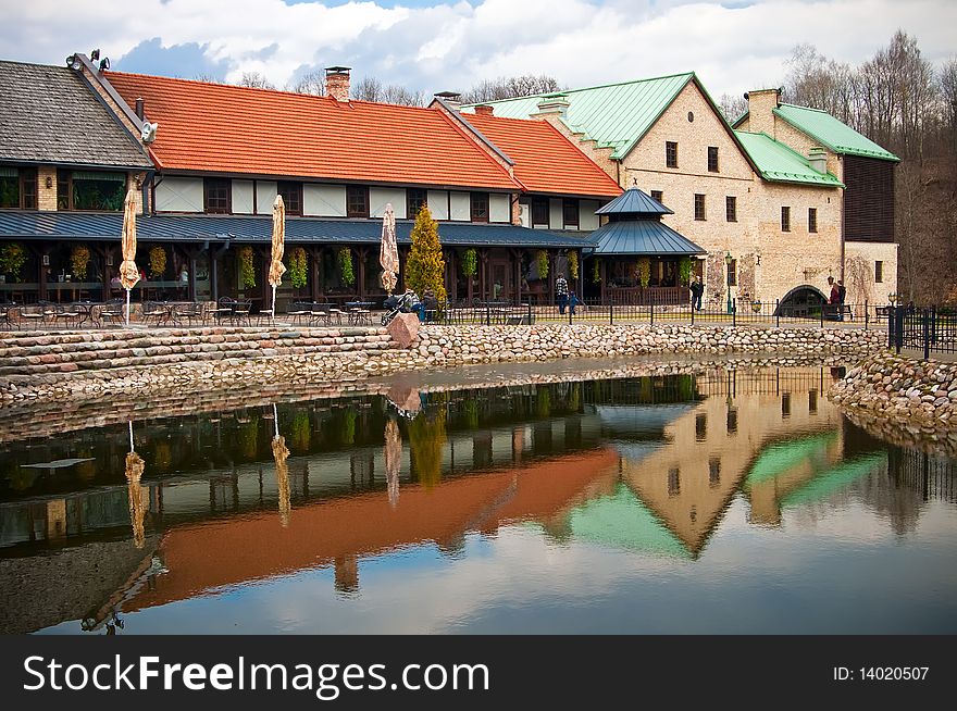 Beautiful view of a building and its reflection in the pond in park Belmontas in Vilnius