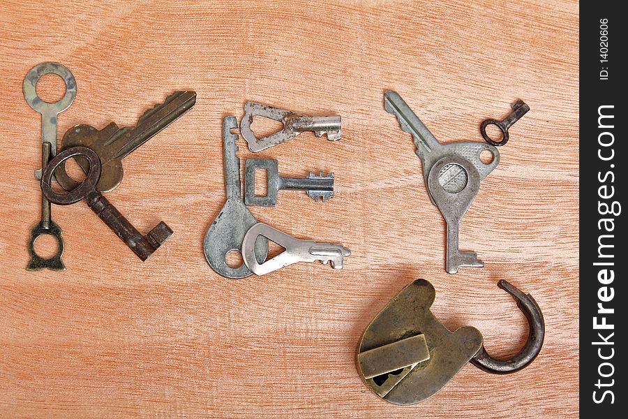 Old padlock and keys on wooden background. Old padlock and keys on wooden background