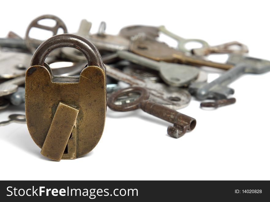 Old padlock and heap of keys isolated on white. Old padlock and heap of keys isolated on white