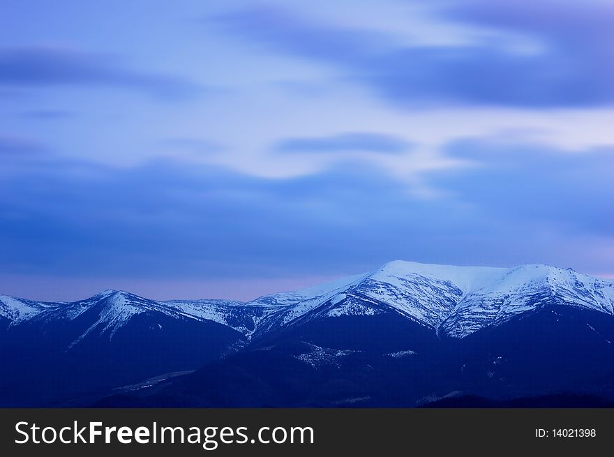 The evening sky with clouds in mountains. The evening sky with clouds in mountains