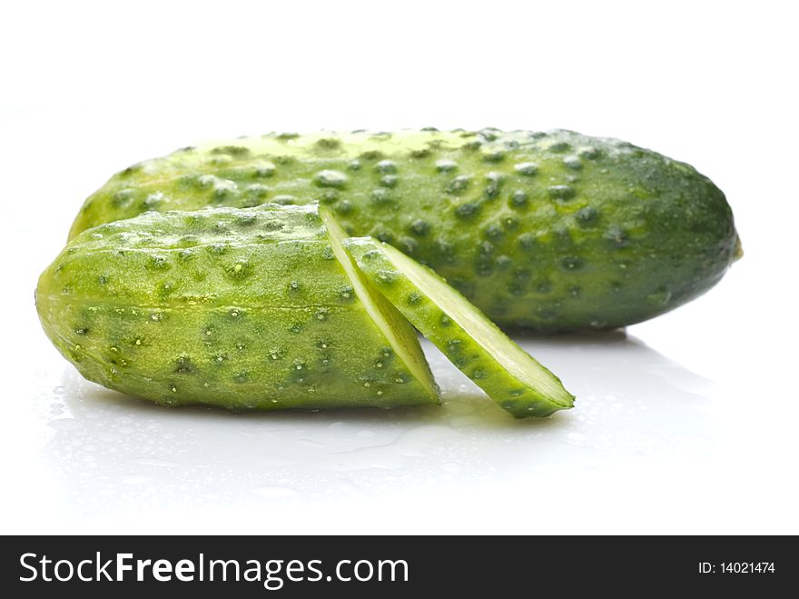 Green cucumber with water drops isolated on white background