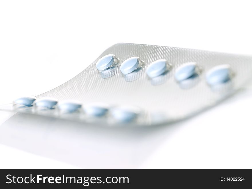 Pack of blue tablets isolated on white